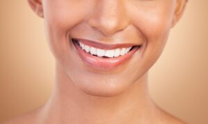 A close-up shot of a woman with white teeth smiling