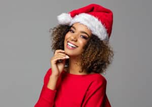 Girl in Santa hat with bright white, perfect smile from dental bonding